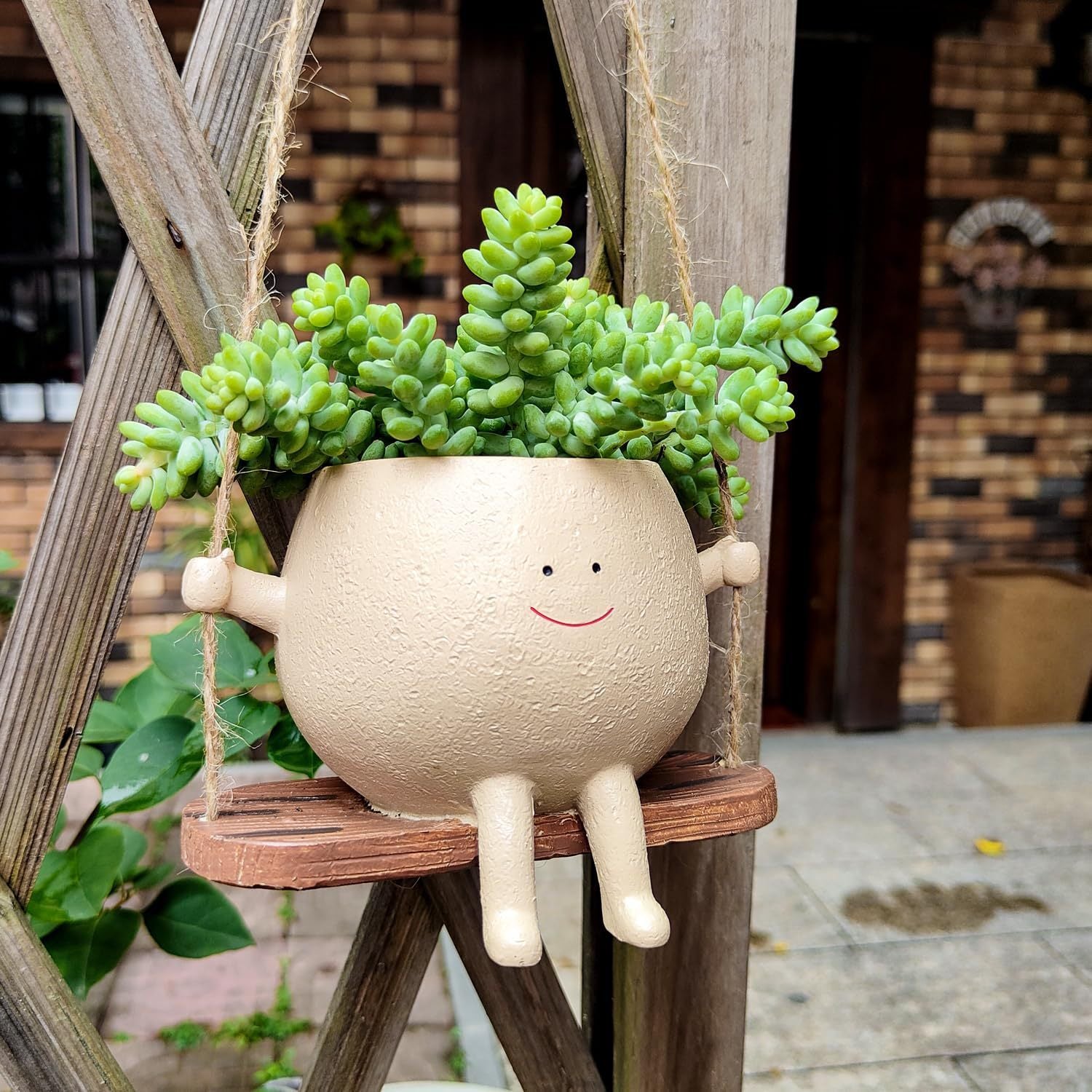 Whimsical swing plant pot for balcony and garden use

